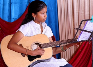 Student performs on guitar