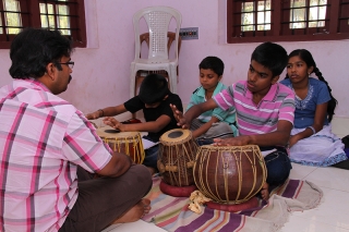 Students learning tabla